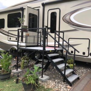 Compact RV deck surrounded by plants