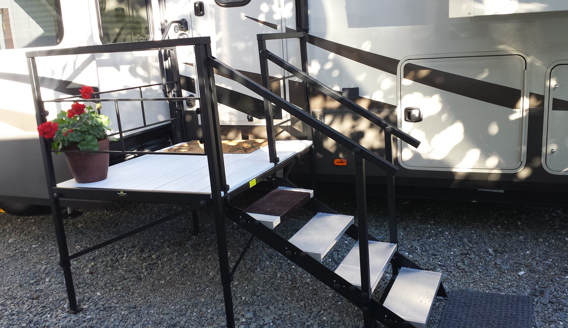 A black metal staircase next to an rv.