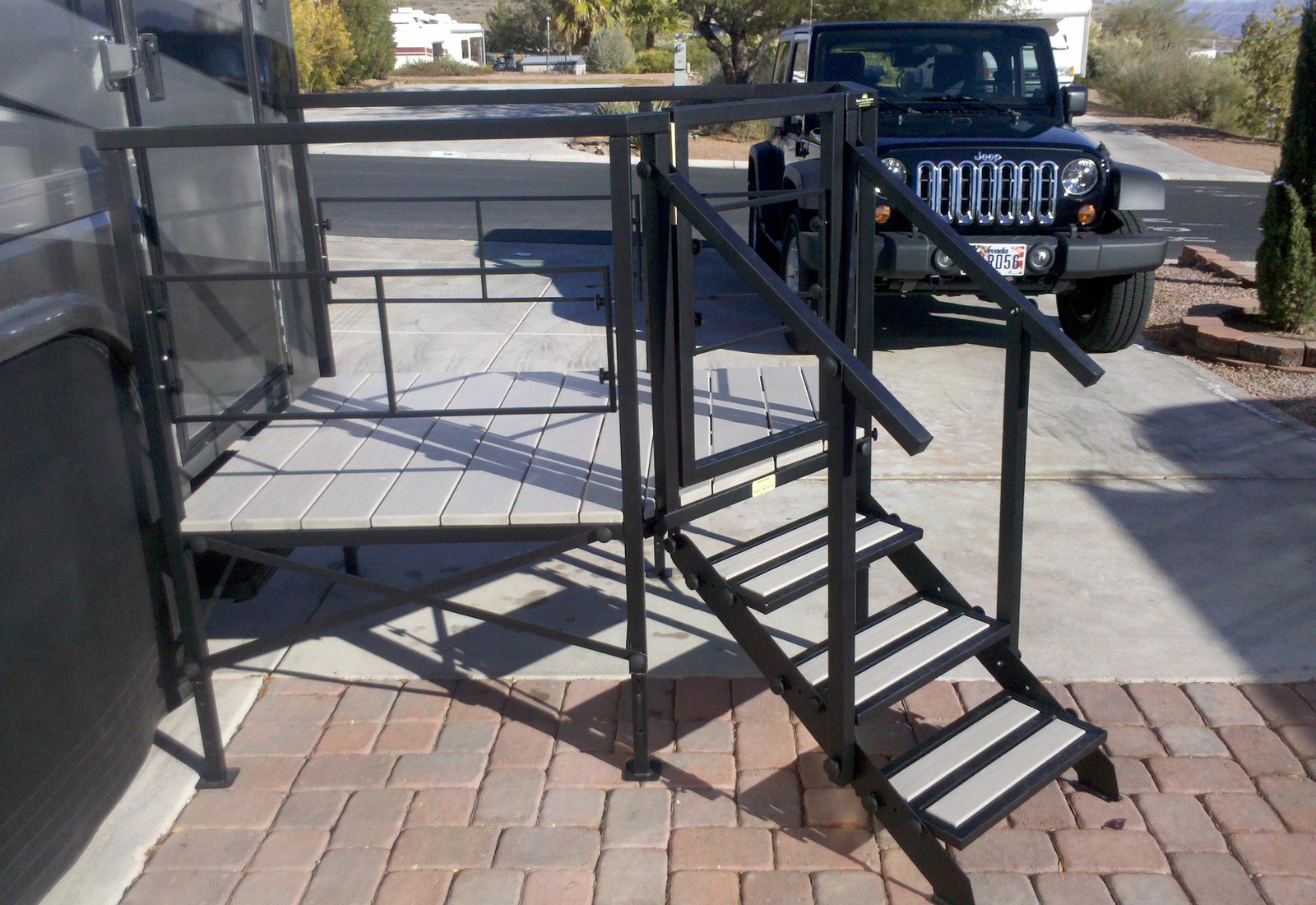 A black metal stair case next to a jeep.