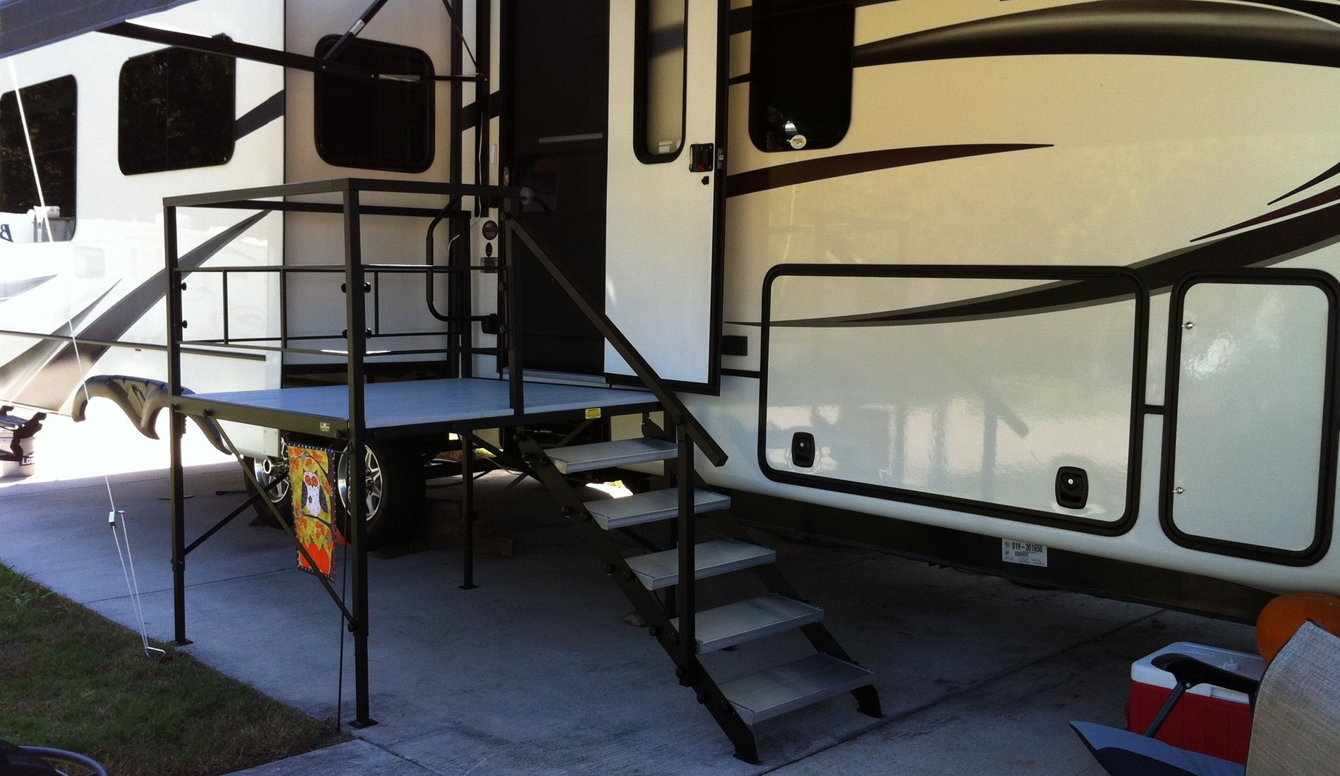 A large rv with stairs leading to the front.